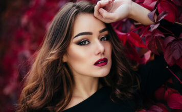 Makeup Inspirations For A Winter Wedding 2023 The beautiful girl stands near walll with leaves-WeddingAffair